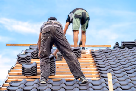 craftsmen-build-new-roof-from-ceramic-tiles-wooden-beams_155027-5351